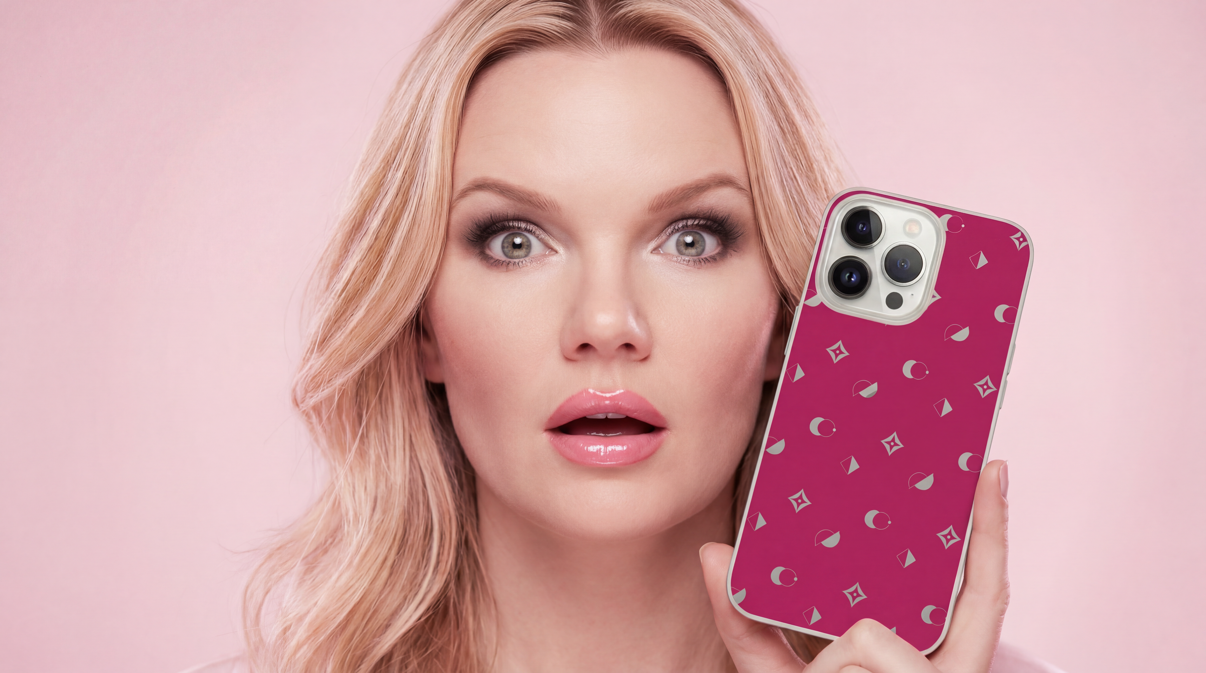Model holding the Whimzy Monogram cerise MagSafe iPhone case on a pink background